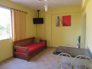 a living room with a couch and a table at Pousada Recanto da Barra in Florianópolis