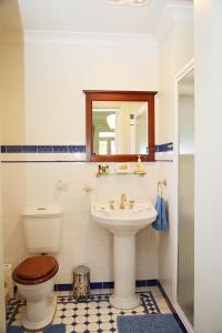 a bathroom with a toilet and a sink at Forgandenny House B&B in Mudgee