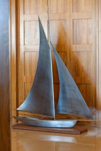 a model of a sail boat on a wooden wall at Hotel Le Grand Pavois in Fécamp
