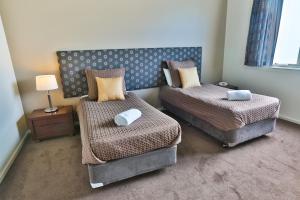 - une chambre avec 2 lits et une chaise dans l'établissement Lady Bay Resort, à Warrnambool