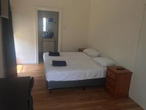 a small bedroom with a bed and a night stand at Gold Coast way Brisbane in Ormeau