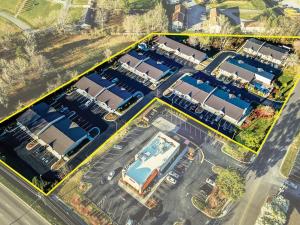 an aerial view of a parking lot with a pool at Super 8 by Wyndham Monroe in Monroe