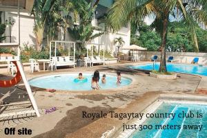 a group of children playing in a swimming pool at MC Mountain Home in Tagaytay
