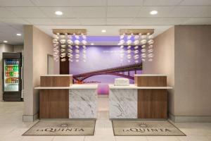 a lobby of a building with a picture of a bridge at La Quinta by Wyndham Lackawanna in Lackawanna +32 photos