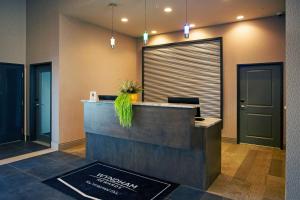 a lobby of a hotel with a reception desk at Wingate by Wyndham Calgary Airport in Calgary