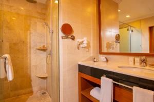 a bathroom with a sink and a shower at Royale Chulan Kuala Lumpur in Kuala Lumpur