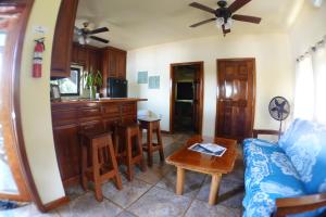 a living room with a couch and a table at Captain Jak's Rentals in Placencia Village