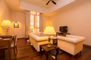 a living room with two couches and a tv at Royale Chulan Kuala Lumpur in Kuala Lumpur