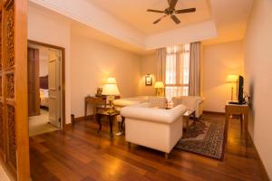 a living room with a couch and chairs and a living room at Royale Chulan Kuala Lumpur in Kuala Lumpur