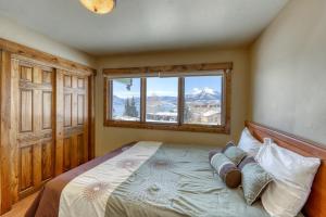 a bedroom with a bed with a large window at 615 Oro Grande in Dillon
