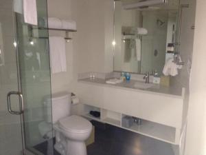 a bathroom with a toilet, sink, and shower at Hotel Parq Central Albuquerque in Albuquerque