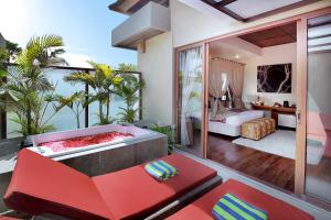 a living room with a tub and a bedroom at Kanishka Villas in Seminyak