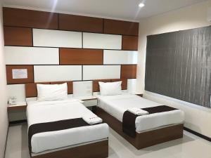 Postel nebo postele na pokoji v ubytování TTT Hotel