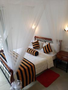 a bedroom with a bed with a canopy at White House Ella in Ella