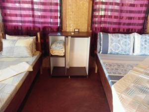 Postel nebo postele na pokoji v ubytování Purple Homestay Hillside