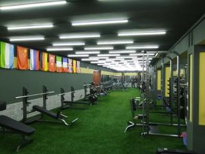 a gym with many rows of exercise equipment and grass at Atlas in Margilan