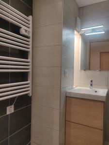 a bathroom with a sink and a mirror at Chez Carole et Arnaud in Val Thorens +70 photos