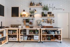 a store with wooden shelves on a white brick wall at Emma's B&B LUNGERN - Self Check-in Hotel in Lungern +173 photos