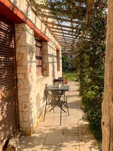 a patio with a table in the middle of a building at Villa in Salento in Lecce