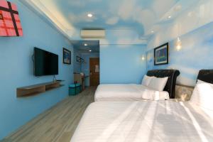 Ein Bett oder Betten in einem Zimmer der Unterkunft Shi Guang Sea View