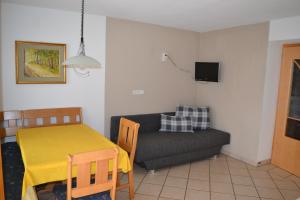 a living room with a table and a couch at Gruberhof in Rodengo