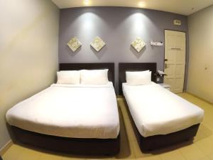 Postel nebo postele na pokoji v ubytování JV Hotel @ Bandar Tasek Mutiara