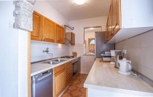 a small kitchen with wooden cabinets and a sink at Silvana in Poreč