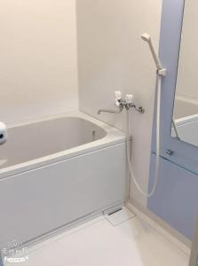 a bathroom with a bath tub with a hose at ひまわり 向日葵 himawari in Takamatsu +21 photos
