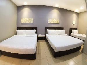 Postel nebo postele na pokoji v ubytování JV Hotel @ Bandar Tasek Mutiara