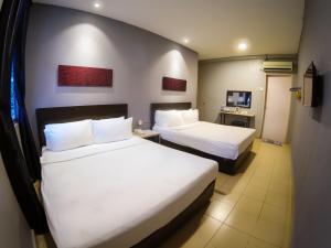 Postel nebo postele na pokoji v ubytování JV Hotel @ Bandar Tasek Mutiara