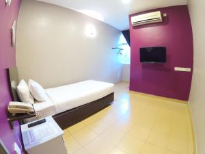 JV Hotel @ Bandar Tasek Mutiara tesisinde bir odada yatak veya yataklar