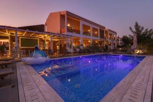 a swimming pool in front of a house at Alegria Suites in Nikiti