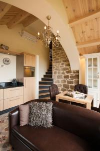 a living room with a couch and a table and stairs at B&B Maison des Etoiles Chambre d'hôtes Adult Only in Verrières