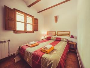 a bedroom with a bed with two towels on it at CABAÑAS RIO MUNDO in Riópar +188 photos