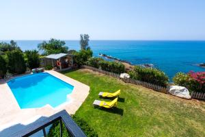 a swimming pool with a view of the ocean at Villa Clarissa & Carmel View in Paphos