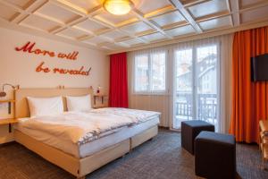 a bedroom with a large bed and red curtains at Chalet Annelis Apartments in Zermatt