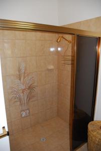 a shower with a glass door with a plant painted on it at Gaerwood B&B in Keith