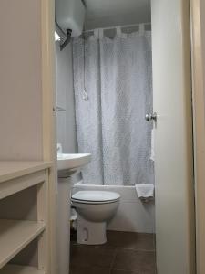 a bathroom with a toilet and a sink at Hostal Lesseps in Barcelona