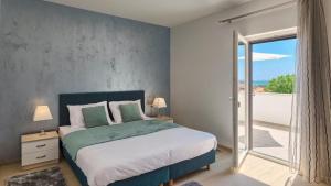 sypialnia z dużym łóżkiem i balkonem w obiekcie Luxury villa Medulin with pool near the beach , sea view, extra pool heating available w Medulinie +29 zdjęć