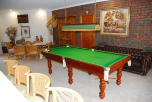 a living room with a pool table and chairs at Gaerwood B&B in Keith
