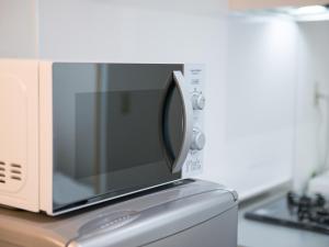 a microwave oven sitting on top of a kitchen counter at Maruka石垣島 in Ishigaki Island
