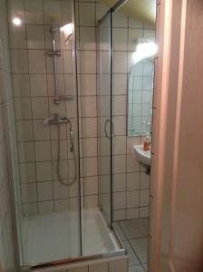 a bathroom with a shower and a tub and a sink at Panama Motel in Székesfehérvár
