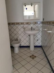 a bathroom with a sink and a toilet at La casa Bianca in Maratea +16 photos