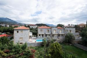 a large stone house with a swimming pool at Manoleas Villas - Apartment 4 in Stoupa