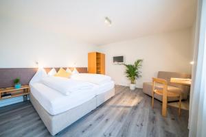 a hotel room with two beds and a table at Hotel & Restaurant Sonne in Schwarzenburg
