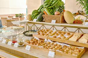 a buffet filled with lots of different types of food at Paris Deli Danang Beach Hotel in Danang