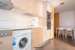 a kitchen with a washer and dryer in it at Alcam Hercules in Barcelona
