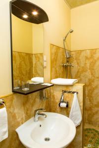 a bathroom with a sink and a mirror at Seven Eleven Most City Hotel&SKYTECH in Dnipro