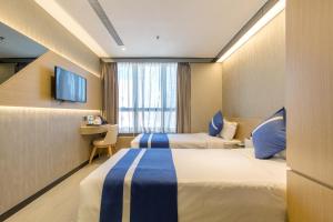A bed or beds in a room at Lumine Hotel