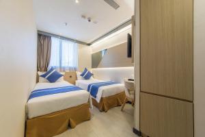 En eller flere senger på et rom på Lumine Hotel